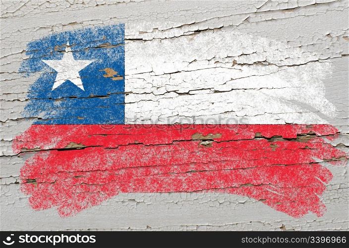 Chalky chile flag painted with color chalk on grunge wooden texture