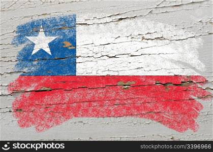 Chalky chile flag painted with color chalk on grunge wooden texture