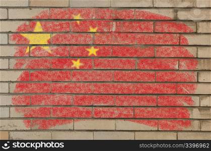 Chalky chinese flag painted with color chalk on grunge old brick wall