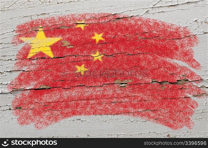 Chalky chinese flag painted with color chalk on grunge wooden texture