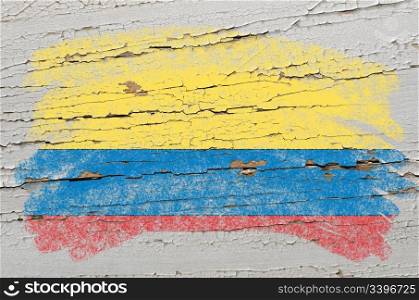 Chalky columbian flag painted with color chalk on grunge wooden texture