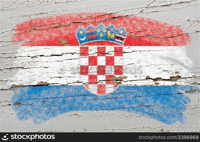 Chalky croatian flag painted with color chalk on grunge wooden texture