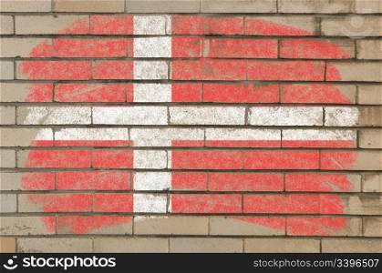 Chalky danish flag painted with color chalk on grunge old brick wall