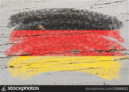 Chalky german flag painted with color chalk on grunge wooden texture