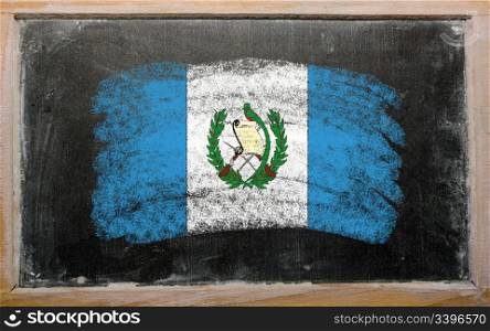 Chalky guatemalan flag painted with color chalk on old blackboard