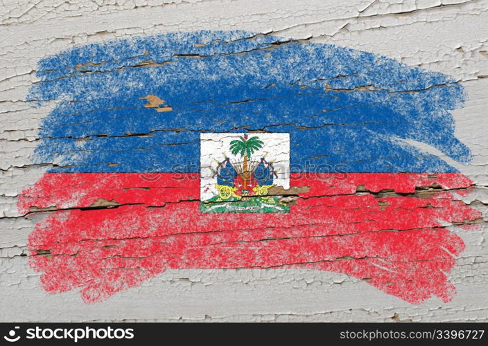 Chalky haitian flag painted with color chalk on grunge wooden texture