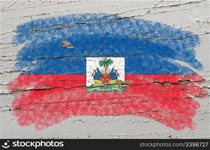 Chalky haitian flag painted with color chalk on grunge wooden texture