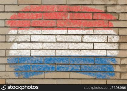 Chalky holland dutch flag painted with color chalk on grunge old brick wall