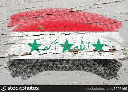 Chalky iraq flag painted with color chalk on grunge wooden texture
