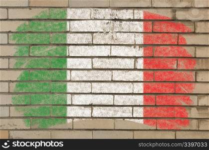 Chalky italian flag painted with color chalk on grunge old brick wall