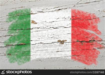 Chalky italian flag painted with color chalk on grunge wooden texture