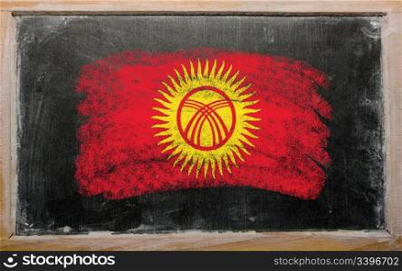 Chalky kyrghyzstan flag painted with color chalk on old blackboard