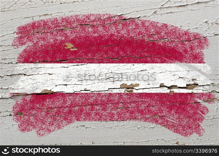 Chalky latvian flag painted with color chalk on grunge wooden texture