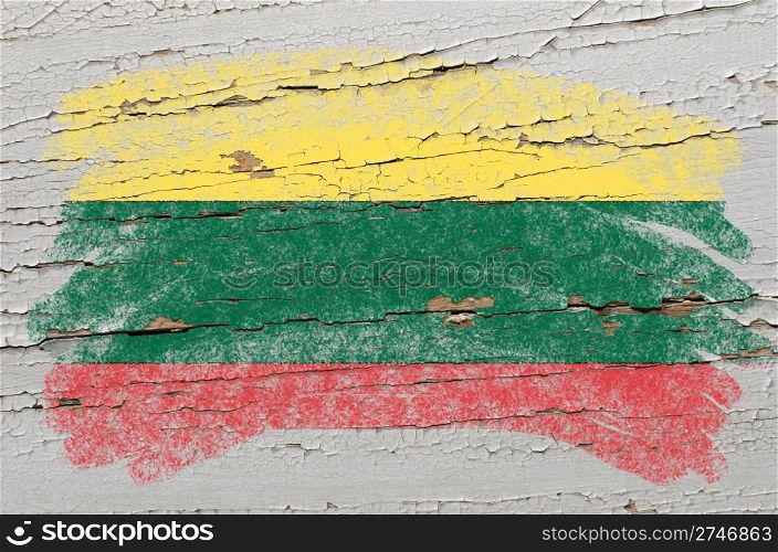 Chalky lithuanian flag painted with color chalk on grunge wooden texture