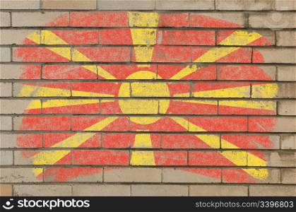 Chalky macedonian flag painted with color chalk on grunge old brick wall