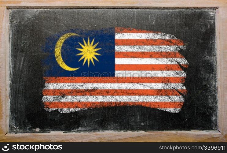 Chalky malaysian flag painted with color chalk on old blackboard
