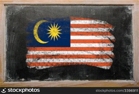 Chalky malaysian flag painted with color chalk on old blackboard