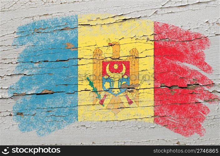 Chalky moldova flag painted with color chalk on grunge wooden texture