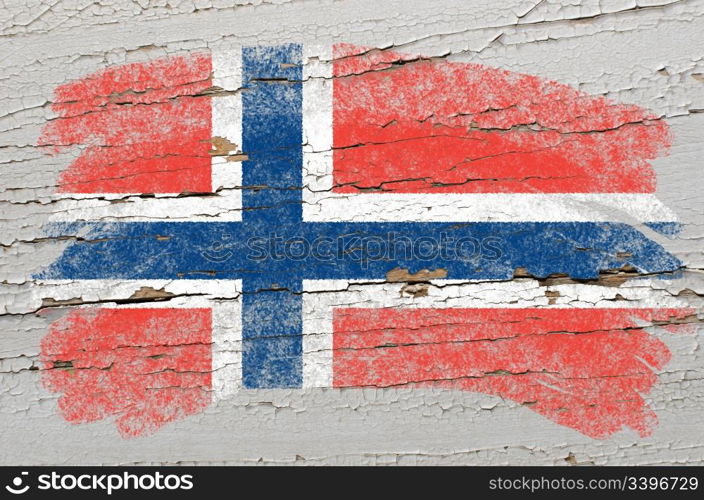 Chalky norwegian flag painted with color chalk on grunge wooden texture