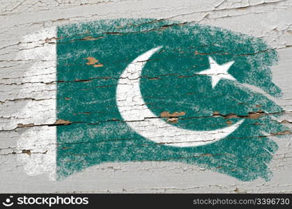 Chalky pakistan flag painted with color chalk on grunge wooden texture