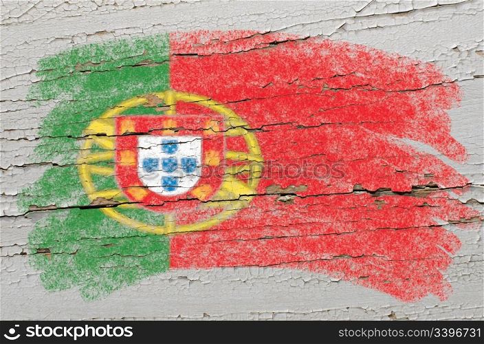 Chalky portugese flag painted with color chalk on grunge wooden texture