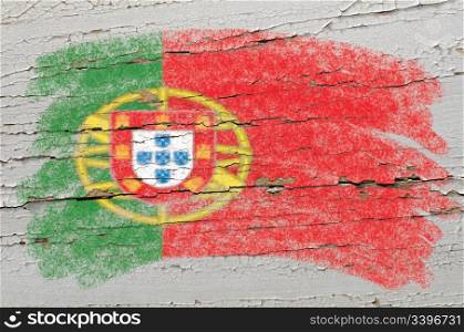 Chalky portugese flag painted with color chalk on grunge wooden texture