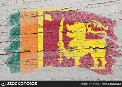 Chalky srilankan flag painted with color chalk on grunge wooden texture