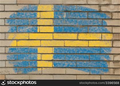 Chalky swedish flag painted with color chalk on grunge old brick wall
