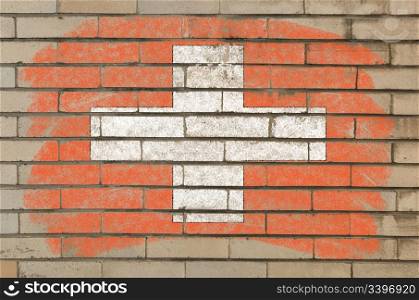 Chalky swiss flag painted with color chalk on grunge old brick wall