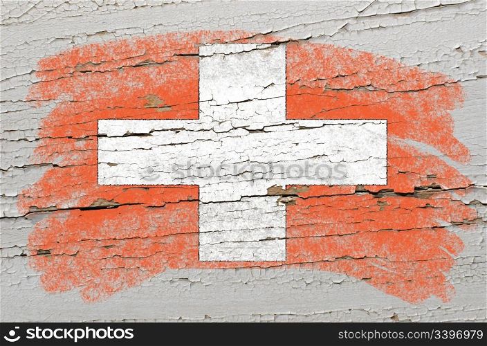 Chalky swiss flag painted with color chalk on grunge wooden texture