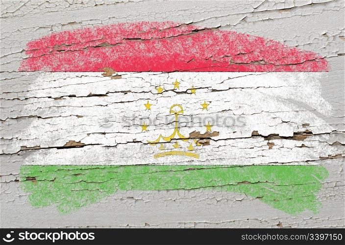 Chalky tajikistan flag painted with color chalk on grunge wooden texture