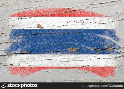Chalky thai flag painted with color chalk on grunge wooden texture