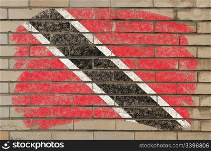 Chalky trinidad and tobago flag painted with color chalk on grunge old brick wall