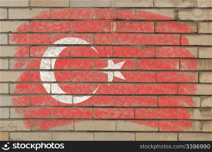 Chalky turkish flag painted with color chalk on grunge old brick wall