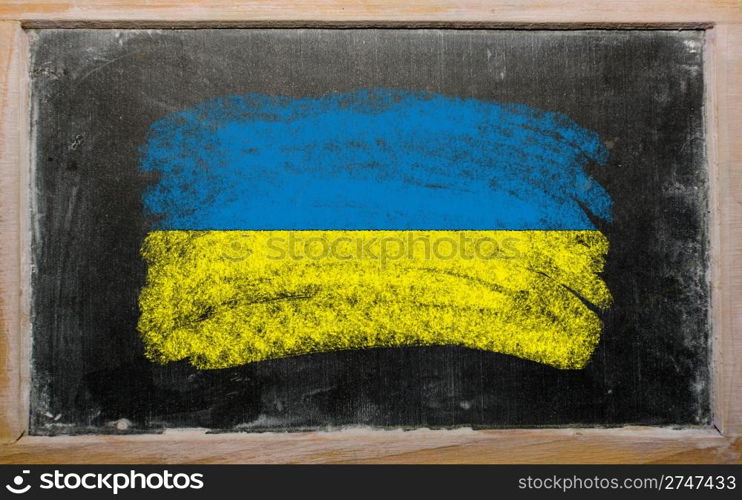 Chalky ukrainian flag painted with color chalk on old blackboard