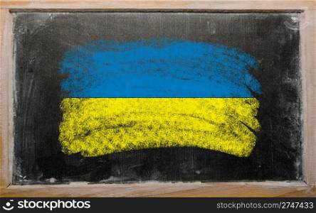 Chalky ukrainian flag painted with color chalk on old blackboard