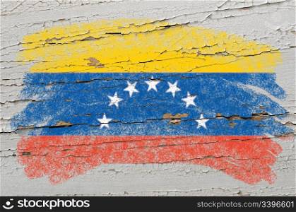 Chalky venezuelan flag painted with color chalk on grunge wooden texture