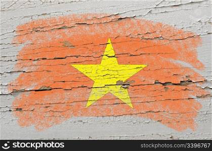 Chalky vietnamese flag painted with color chalk on grunge wooden texture