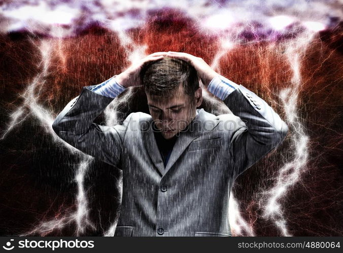 Challenge in business. Frustrated businessman protecting his head with arms