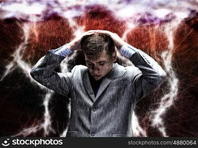 Challenge in business. Frustrated businessman protecting his head with arms