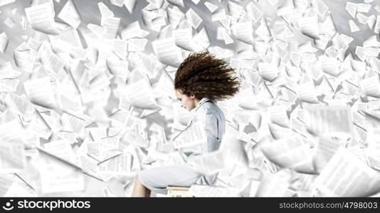 Challenge in business. Young businesswoman with waving hair sitting on chair