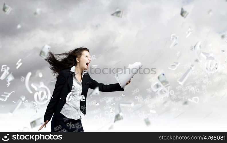 Challenge in business. Young determined businesswoman walking against strong wind