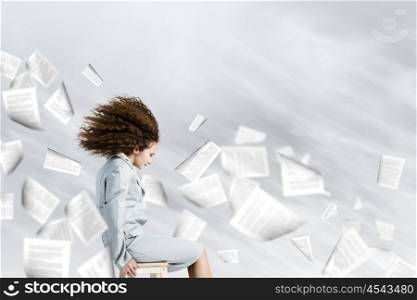 Challenge in business. Young tired businesswoman with waving hair among flying documents