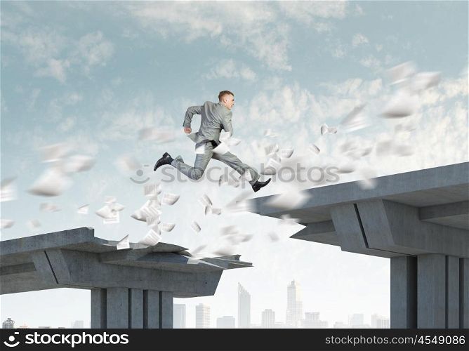 Challenge overcoming. Young businessman jumping over bridge gap. Risking in business