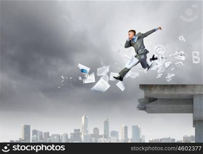 Challenge overcoming. Young businessman jumping over bridge gap. Risking in business