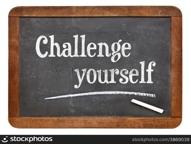 Challenge yourself - motivational text on a vintage slate blackboard