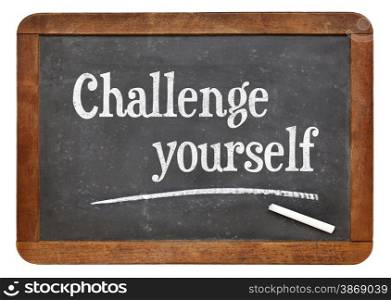 Challenge yourself - motivational text on a vintage slate blackboard