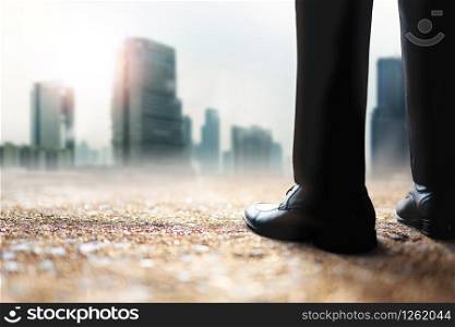 Challenging of Business Company to Helping World Environment and Global Warming Issue. Low Section of Businessman Standing to Looking at Urban Building in Haze Hot Light