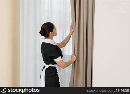 chambermaid cleaning hotel room