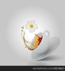 Chamomile tea. White cup of tea with chamomile flower